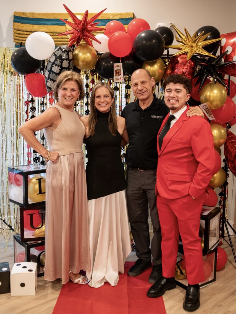 Four people posing at a Park Place community event