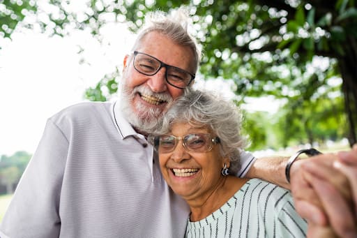 Older couple taking a selfie outdoors