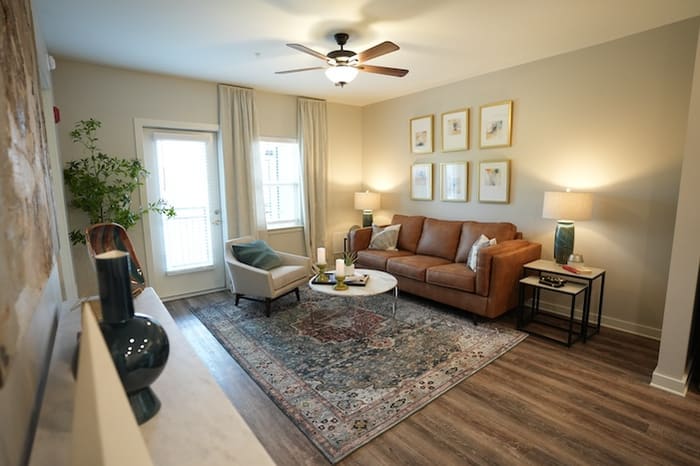 Avonlea living room with sofa and balcony door